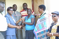 Makhado Municipality Mayor Mavhungu Luruli officially handing the keys for the new house to Elisa Mulaudzi while a contractor Tshipuliso Barnabas Tshisikule and other community members looks on